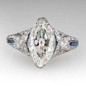 Macro shot of an Art Deco ring with marquise-cut center stone and blue sapphire accents