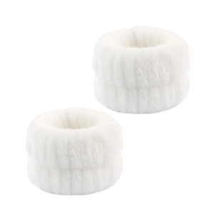 Detailed macro view of a pair of plush white microfiber wrist washbands for skincare