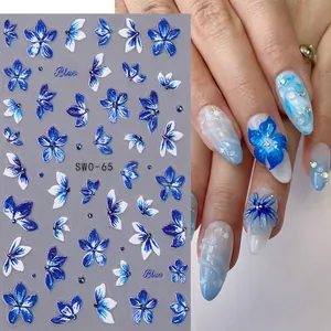 3D embossed blue lily and butterfly nail stickers with floral patterns on a white base