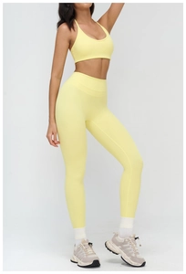 Detail view of seamless light yellow yoga set showing stretch fit and high waist