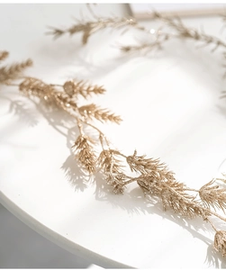 Close-up of golden glitter pine needles branch for elegant Christmas tree decoration