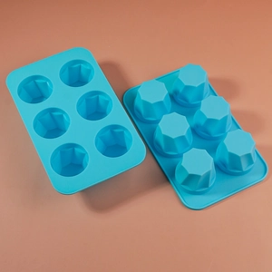 Detailed close-up of 6-cavity blue silicone mold with geometric faceted patterns