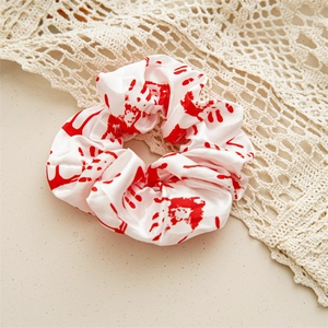 Detail view of satin scrunchie with red blood handprints for Halloween theme