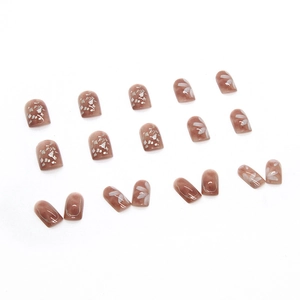Square medium amber red press-on nails with white floral patterns and silver foil accents