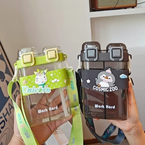 Close-up of dual-chamber children's cups with unicorn and penguin cartoon designs and straps