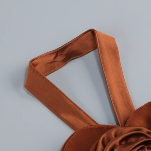 Detail of the caramel satin halter neck strap showing smooth fabric and stitching