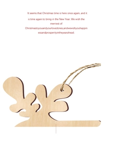 Detail of laser-cut wooden reindeer ornament with natural texture and jute twine string