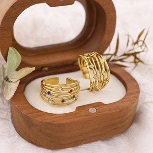 French style gold multi-layer open rings set with colorful gemstones in a wooden box
