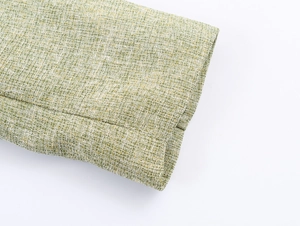 Close-up of the tweed texture and stitching on the cuff of the green mixed jacket