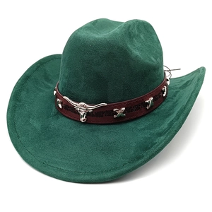 Detail of dark green suede cowboy hat featuring brown leather band and silver bull head icon
