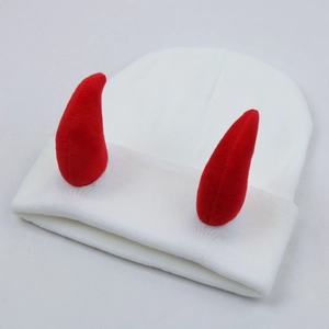 White knitted beanie featuring prominent red devil horns on a clean white background