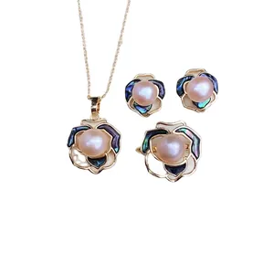 Elegant camellia jewelry set with pink freshwater pearls and colorful abalone shell in gold