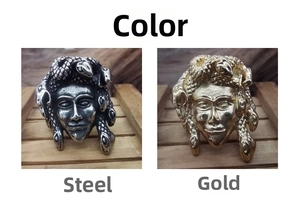 Detail showing Medusa head rings in gold and steel finishes with punk design