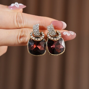 Detail of vintage square wine red crystal earrings with sparkling rhinestone accents