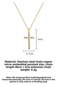 Macro detail of gold cross pendant showing zircon inlay and chain measurement details