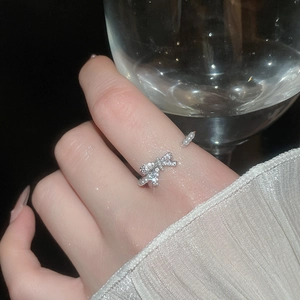 Detail of zircon bowknot ring with pearls showing sparkling stones and silver finish