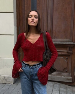 Close-up of deep red hollow knit cardigan featuring V-neck and stylish bell sleeves