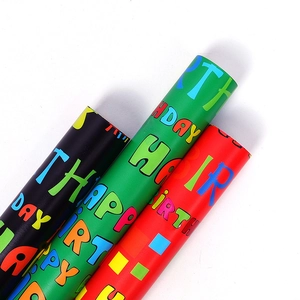 Three rolls of colorful Happy Birthday wrapping paper in black, green, and red glossy finish