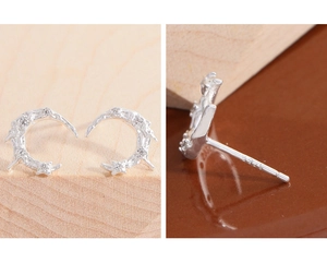 Macro view of S925 sterling silver moon studs with micro-inlaid cubic zirconia