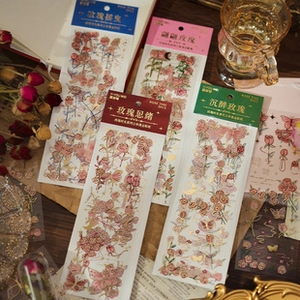 Macro view of vintage rose stickers with gold foil details on retro paper background