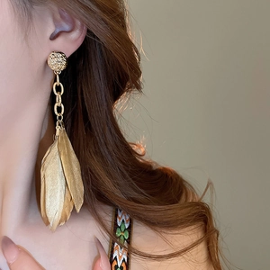 Vintage gold feather tassel earrings with a round textured stud for a retro royal look