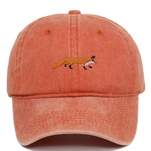 Detailed view of fox embroidery on a vintage washed orange cotton baseball cap