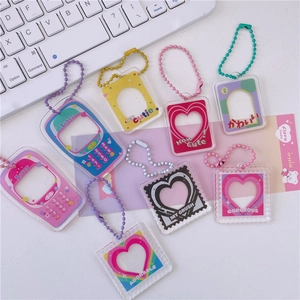 Flat lay of macaron acrylic photo frame keychains with colorful ball chains and charms