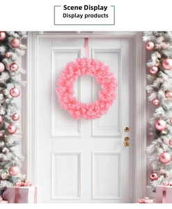 Detailed view of a cherry pink Christmas wreath hanging on a classic white wooden door