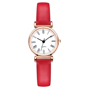 Detail view of quartz watch with red leather strap, rose gold case and Roman numerals