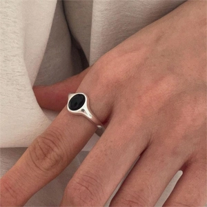 Minimalist 925 sterling silver ring featuring a black oval onyx gemstone on hand
