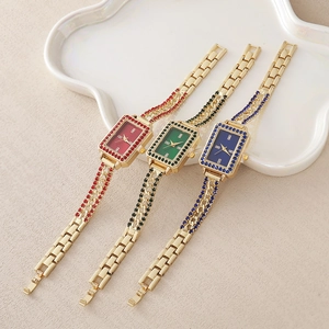 Luxury women's quartz watch set in gold with red green and blue rhinestone accents