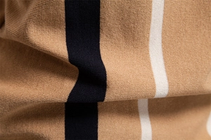 Macro detail of khaki knitted polo fabric with vertical black and white stripe patterns