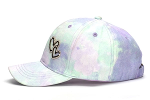 Close-up of children's colorful tie-dye baseball cap with rhinestone heart detail
