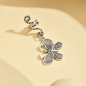 Detail view of silver butterfly pendant hair ring with textured spiral design for dreadlocks