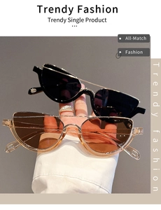 Detail of trendy black and translucent tea cat eye sunglasses with metallic bridge