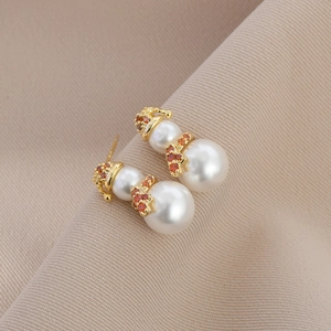 Detailed view of pearl snowman earrings with red crystal hat and scarf festive jewelry