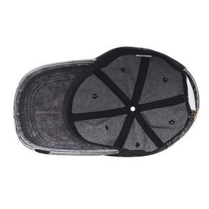Detail view of the washed denim baseball cap interior showing the 100% cotton label