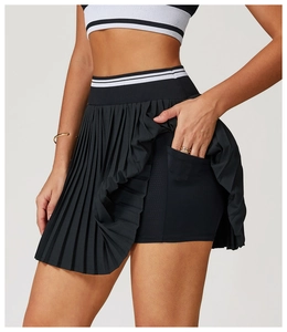 Detail shot of black pleated sports skirt featuring inner shorts with side phone pocket