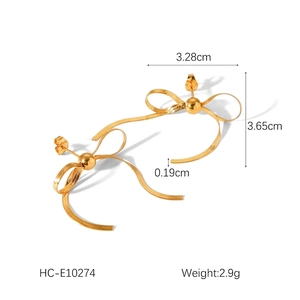 Macro view of 18k gold plated stainless steel bow earrings with snake chain texture