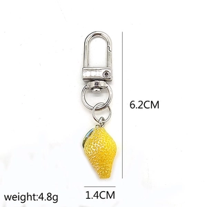 Detailed view of mini lemon keychain pendant with 6.2cm length and 1.4cm width specs
