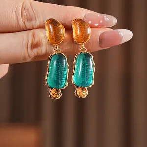 Vintage style oval resin drop earrings with orange and green stones and gold metal details