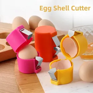 Manual stainless steel egg cracker set in pink, orange, and yellow for kitchen use