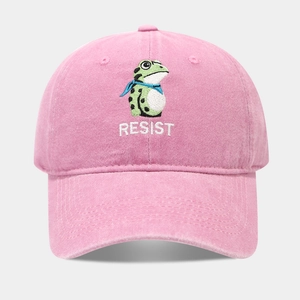 Close-up of pink washed cotton baseball cap with frog and Resist embroidery detail