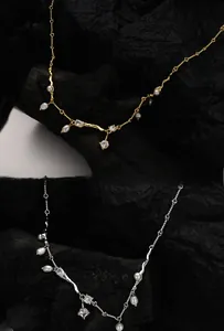 Detail of silver and gold necklaces with irregular pearls and sparkling crystals