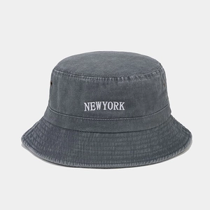 Macro detail of NEWYORK embroidery and eyelet on washed cotton retro bucket hat