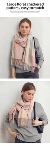 Close-up of pastel pink and grey plaid scarf featuring soft cashmere-like texture and fringe