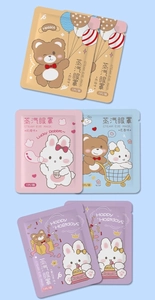 Various heated steam eye masks in grapefruit, rose, and lavender scents on blue background
