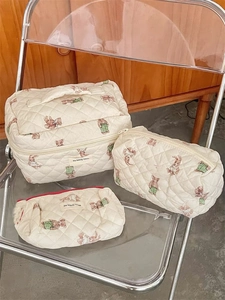 Three-piece set of beige quilted cosmetic bags with cute bear pattern in various sizes