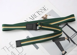 Detail of striped canvas belt with black double D-ring buckle on fashion magazine