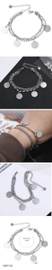 Macro view of multi-layer steel bracelet with silver circular pendants and S925 hallmark